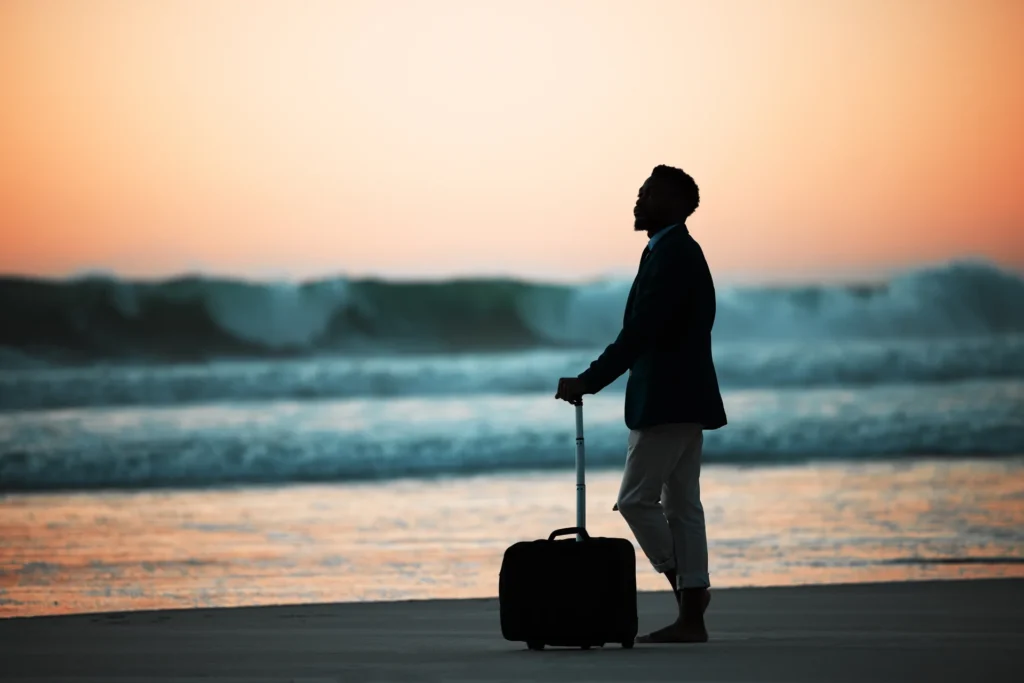 Hombre en la playa con la puesta de sol
